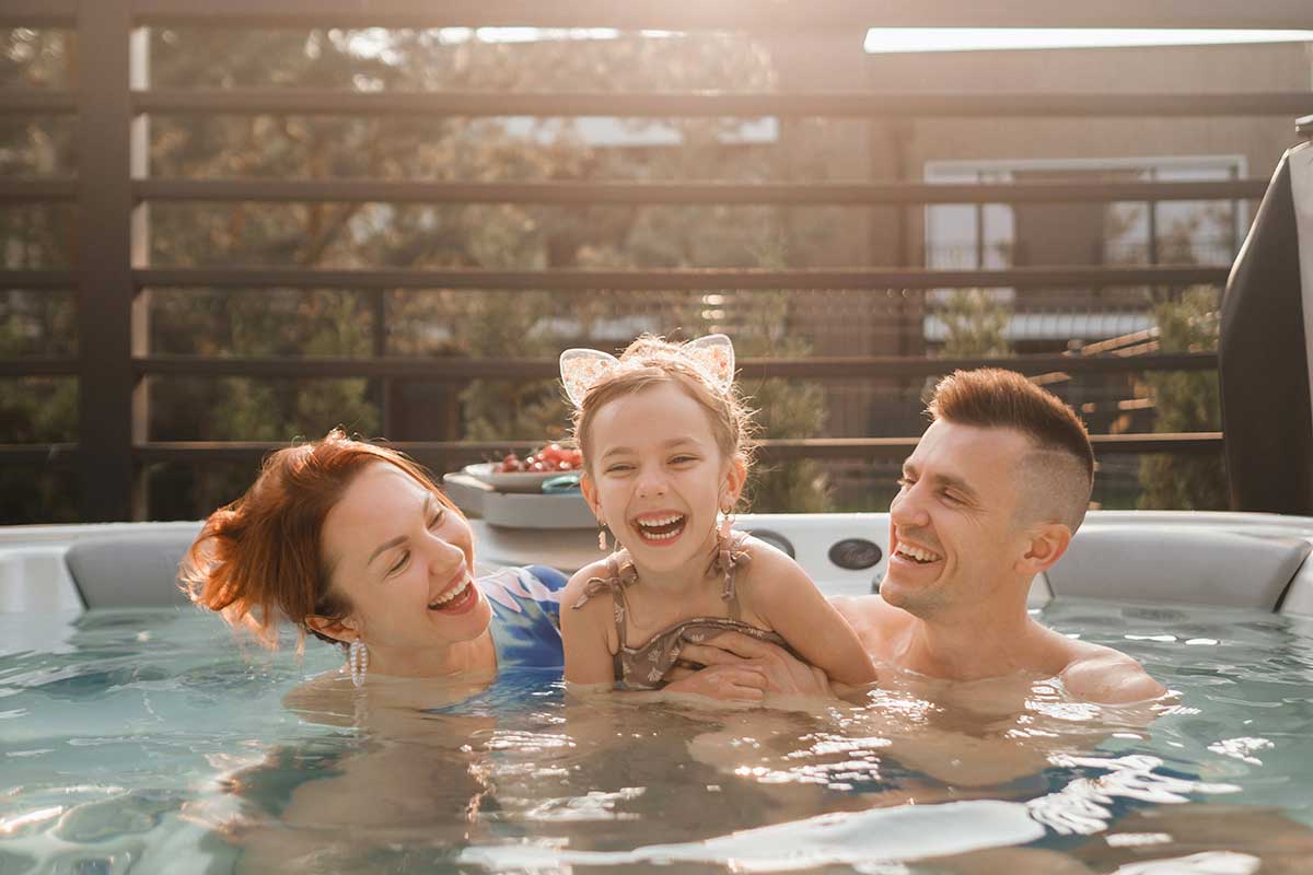 Family rests in the outdoor hot tub-Empire Pool & Patio